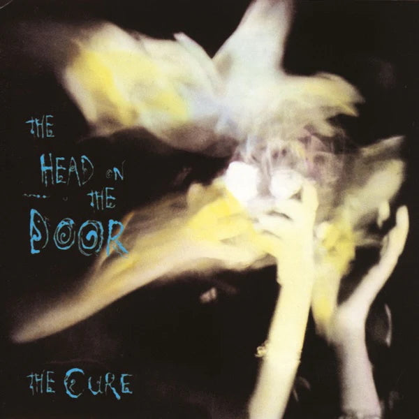 Album cover of 'The Head on the Door' by The Cure featuring a bird and text.